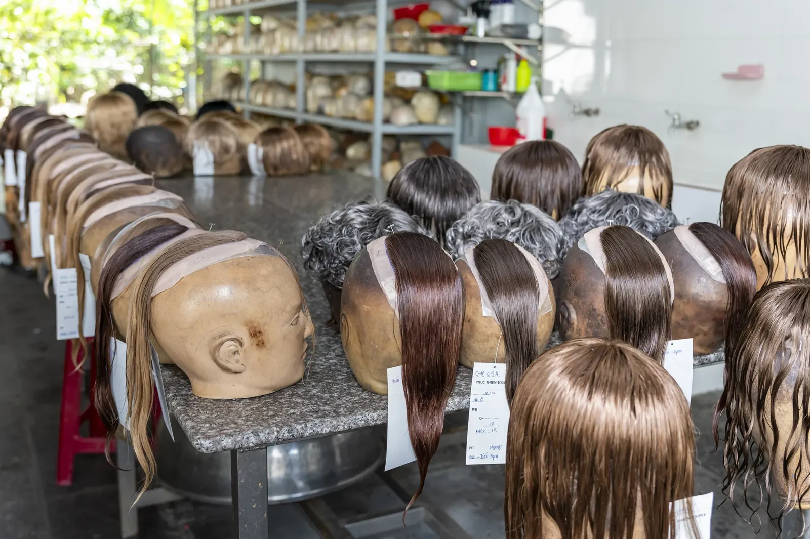 Hairpieces on forms in the Phuc Thien Toupee finishing area